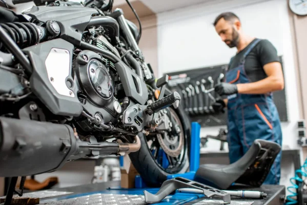 motorcycle-with-worker-at-the-workshop-e1697481290476.jpg